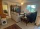 Cozy living room with comfortable seating, a media center, and ample natural light streaming through the windows at 25228 E Lenox Cir, Punta Gorda, FL 33950