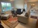 Comfortable living room with sofas, chairs, and a dining area with a table set for six at 25228 E Lenox Cir, Punta Gorda, FL 33950