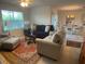 Inviting living room with neutral walls, comfortable seating, and a bright window for natural light at 25228 E Lenox Cir, Punta Gorda, FL 33950