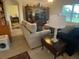 Comfortable living room with plush sofas, a media center, and large windows offering serene views at 25228 E Lenox Cir, Punta Gorda, FL 33950