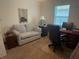 A bright office offers space for both work and relaxation with a desk and a comfortable sofa at 25228 E Lenox Cir, Punta Gorda, FL 33950