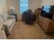 A bright office offers space for both work and relaxation with a desk, TV, and a comfortable sofa at 25228 E Lenox Cir, Punta Gorda, FL 33950