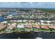 Aerial view of the waterfront property featuring a pool, boat dock, and surrounding community at 2814 La Mancha Ct, Punta Gorda, FL 33950