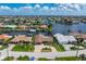 An aerial view of a single-Gathering home with waterfront access and mature landscaping at 2814 La Mancha Ct, Punta Gorda, FL 33950