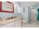 Bathroom with granite counters, framed mirror, and tiled shower at 2814 La Mancha Ct, Punta Gorda, FL 33950