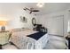 Bedroom with a ceiling fan, white tile flooring, and a blue octopus art piece on the wall at 2814 La Mancha Ct, Punta Gorda, FL 33950