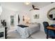 Bedroom featuring tile flooring, ceiling fan, desk area, and wall decorations at 2814 La Mancha Ct, Punta Gorda, FL 33950