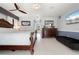 Primary bedroom features a ceiling fan, tile flooring, and large closet with a barn door at 2814 La Mancha Ct, Punta Gorda, FL 33950