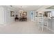 Open-concept dining area with stylish lighting and access to the kitchen and living spaces at 2814 La Mancha Ct, Punta Gorda, FL 33950