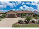 Charming single-story home with a paver driveway, lush landscaping, and a two-car garage at 2814 La Mancha Ct, Punta Gorda, FL 33950