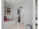 Hallway with an arched entry features tiled floors, built-in storage and an ornate light fixture at 2814 La Mancha Ct, Punta Gorda, FL 33950