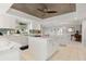 Open kitchen with marble countertops, white cabinets, and a central island at 2814 La Mancha Ct, Punta Gorda, FL 33950