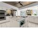 View of the kitchen with an island with quartz countertops and stainless appliances at 2814 La Mancha Ct, Punta Gorda, FL 33950