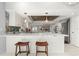 Breakfast bar with quartz countertops and woven bar stools in kitchen at 2814 La Mancha Ct, Punta Gorda, FL 33950