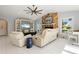 Bright living room showcases a stone fireplace, entertainment center, tile flooring, and waterfront views at 2814 La Mancha Ct, Punta Gorda, FL 33950