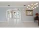 Bright living room featuring arched doorways, tile floors, and decorative lighting at 2814 La Mancha Ct, Punta Gorda, FL 33950