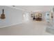Spacious living room with guitar hanging on the wall and bright white floors at 2814 La Mancha Ct, Punta Gorda, FL 33950