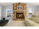Inviting living room features a stone fireplace, windows, and comfortable seating with waterfront views at 2814 La Mancha Ct, Punta Gorda, FL 33950