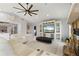 Open concept living room offers tile flooring, a fireplace, built-in entertainment center and comfortable furniture at 2814 La Mancha Ct, Punta Gorda, FL 33950