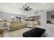 Spacious living room features tile flooring, a ceiling fan, and an open layout to the kitchen at 2814 La Mancha Ct, Punta Gorda, FL 33950