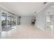 A spacious, airy room featuring sliding glass doors and neutral tile flooring at 2814 La Mancha Ct, Punta Gorda, FL 33950