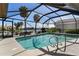 Screened-in pool overlooking waterfront views with a pool and outdoor seating at 2814 La Mancha Ct, Punta Gorda, FL 33950