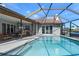 Relaxing swimming pool with an outdoor dining area perfect for entertaining guests and enjoying the sunny weather at 2814 La Mancha Ct, Punta Gorda, FL 33950