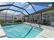 Inviting swimming pool with screened enclosure and an adjoining patio offering comfortable seating and a dining area at 2814 La Mancha Ct, Punta Gorda, FL 33950