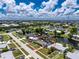 Aerial view highlighting a charming single-Gathering home nestled along a canal, offering serene waterfront living and convenient city access at 330 Weber Ter, Port Charlotte, FL 33952
