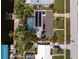 A high angle view of a house with a pool, patio, solar panels and lush greenery, and a large dock at 330 Weber Ter, Port Charlotte, FL 33952