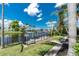 Backyard view with canal access, lush greenery, and a wrought iron fence at 330 Weber Ter, Port Charlotte, FL 33952