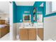 Bright bathroom featuring a vanity with wood cabinets, a mirror and a toilet at 330 Weber Ter, Port Charlotte, FL 33952