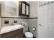 Bathroom featuring a vanity, mirror, toilet, grey tiling and towel rack at 330 Weber Ter, Port Charlotte, FL 33952