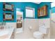 Bright blue bathroom with tiled walls, neutral accents and stylish vanity at 330 Weber Ter, Port Charlotte, FL 33952