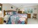 Inviting bedroom with tropical bedding, wooden furniture, and plantation shutters at 330 Weber Ter, Port Charlotte, FL 33952