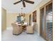 Cozy dining room featuring a unique chandelier, woven chairs, and shuttered windows at 330 Weber Ter, Port Charlotte, FL 33952