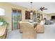 Dining room with woven chairs, shuttered windows, and an open floor plan at 330 Weber Ter, Port Charlotte, FL 33952