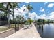 Dock with patio, seating area, and waterfront view on a sunny day at 330 Weber Ter, Port Charlotte, FL 33952