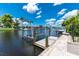 Waterfront view with a private boat lift, canal access, and a beautiful blue sky at 330 Weber Ter, Port Charlotte, FL 33952