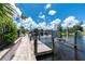 Wooden dock with boat lift on the water, along with patio at 330 Weber Ter, Port Charlotte, FL 33952