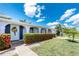 Inviting home exterior with a floral wreath and vibrant flower hedge enhances curb appeal at 330 Weber Ter, Port Charlotte, FL 33952