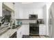 Well-lit kitchen features stainless steel appliances, granite countertops, and ample cabinet space at 330 Weber Ter, Port Charlotte, FL 33952