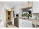 Updated kitchen with stainless steel appliances, white cabinets and view of the backyard at 330 Weber Ter, Port Charlotte, FL 33952