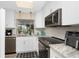 Bright kitchen features granite countertops, stainless steel appliances, and white cabinetry at 330 Weber Ter, Port Charlotte, FL 33952