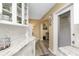 Kitchen detail showcasing marble countertops and white cabinets with glass display shelves at 330 Weber Ter, Port Charlotte, FL 33952