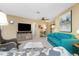 Comfortable living room featuring a plush blue sofa and stylish furnishings at 330 Weber Ter, Port Charlotte, FL 33952