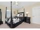 Bedroom featuring a four-poster bed, nightstand, ceiling fan, and neutral walls at 330 Weber Ter, Port Charlotte, FL 33952