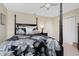 Bedroom featuring a four-poster bed, nightstand, ceiling fan, and neutral walls at 330 Weber Ter, Port Charlotte, FL 33952