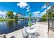 Inviting outdoor patio with table, chairs, umbrella and canal view at 330 Weber Ter, Port Charlotte, FL 33952