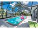 Screened in pool area with view of water and lounge chairs at 330 Weber Ter, Port Charlotte, FL 33952